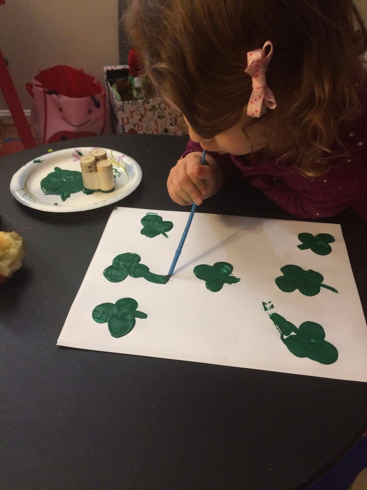 G painting stems on the shamrocks