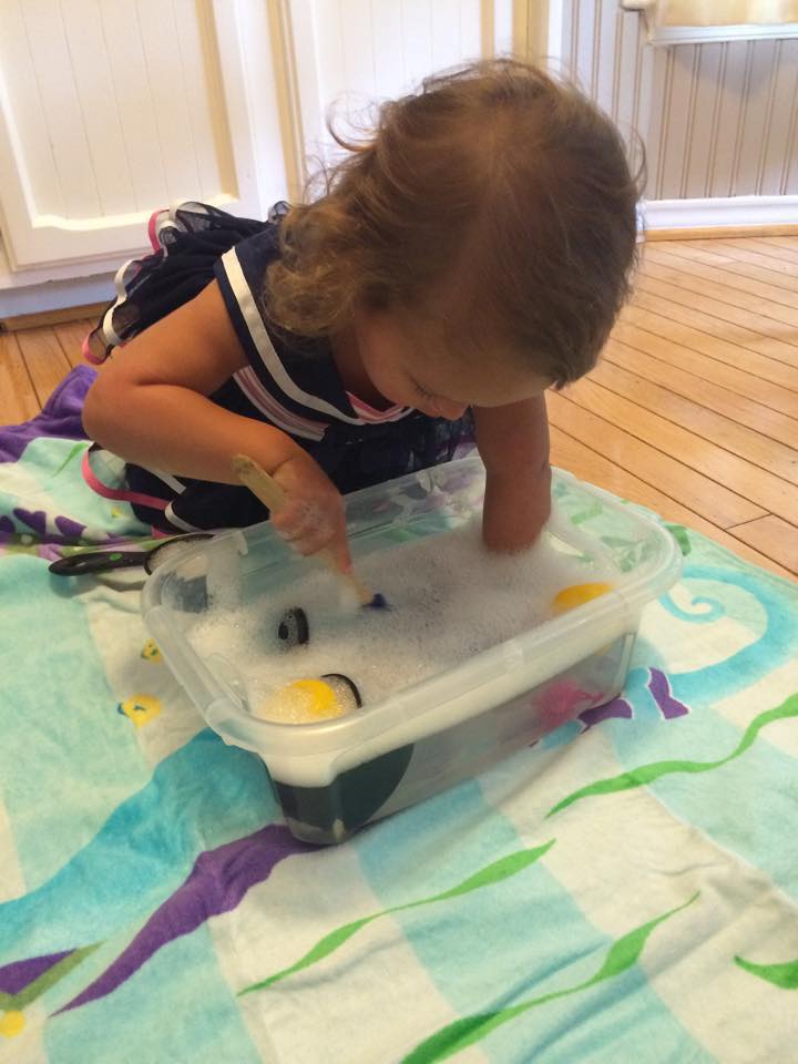 G playing in the water bin